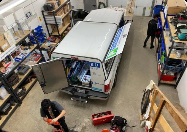 Preferred Plumbing technicians loading a service van in the shop